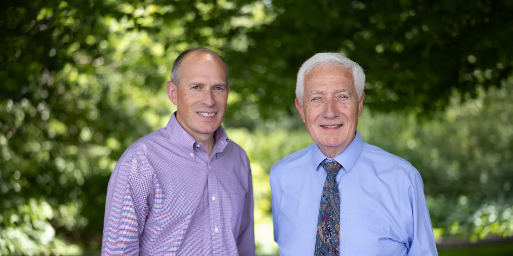 Chiropractors Dr Scott Lally and Thomas Lally Smiling Outdoors