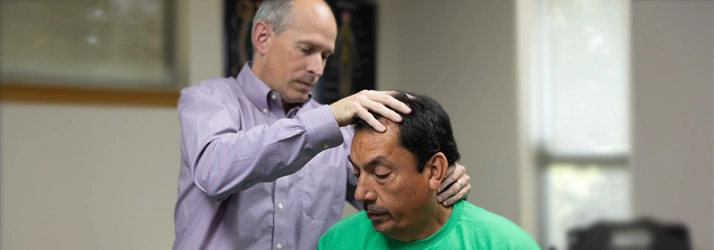 Dr. Scott Lally providing a gentle neck adjustment to relieve whiplash symptoms at Lally Chiropractic Clinic in Yakima, WA.