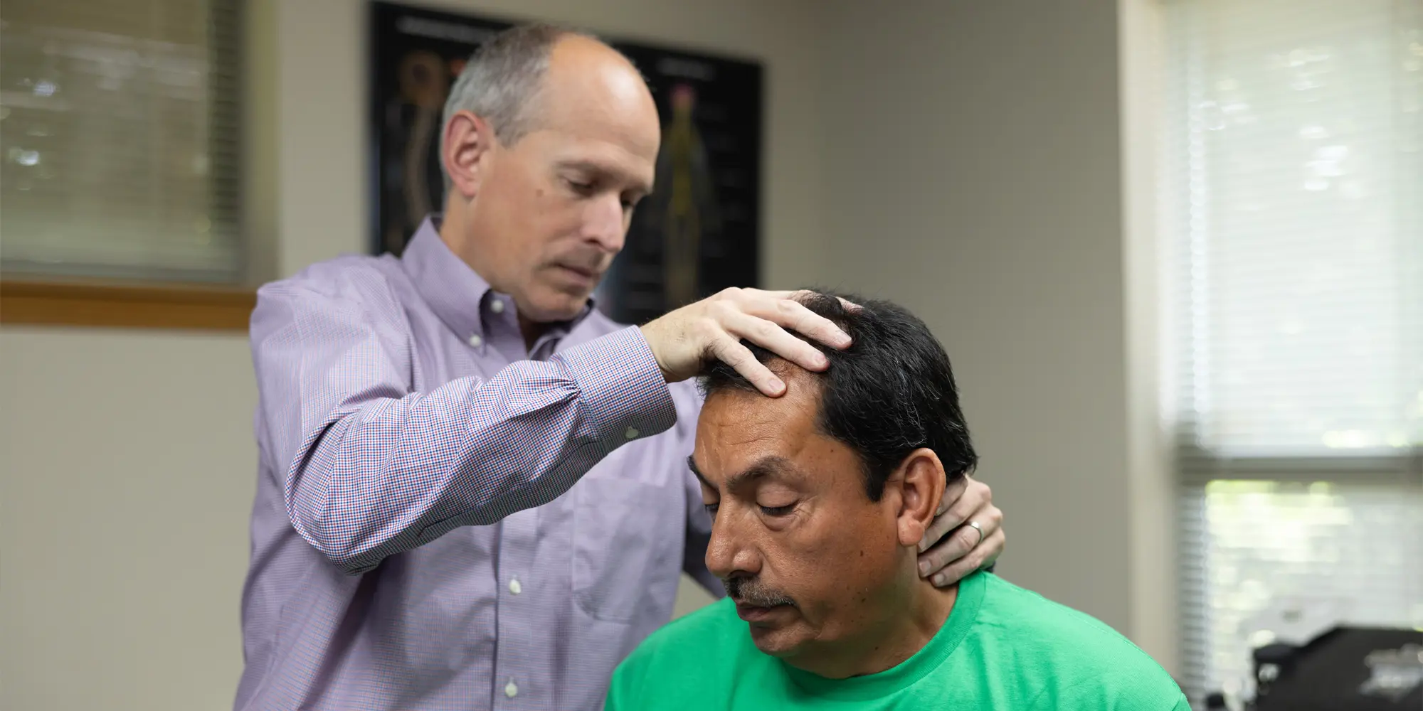 Dr. Scott Lally providing a hands-on chiropractic neck and spinal adjustment to a patient at his Yakima clinic